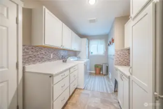 Large laundry room with cabinets and sink