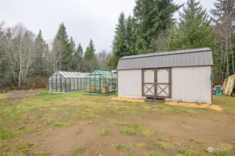 The out building on the right is another 10x20 used for storage. Also has power and lights. One large green house and one smaller green house on the left.