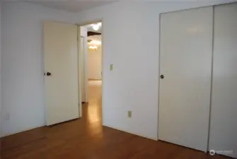 View from the 2nd bedroom looking out into the bedroom area hall.  Wonderful bamboo flooring.