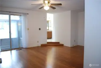 Double doors lead into the primary suite.  Suite has bamboo floors, a slider to the atrium, double closets, a wall AC unit, and a soaker tub.