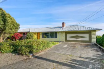 Level in to this Mid-Century gem with large driveway & 2 Car Garage. Newer metal roof!