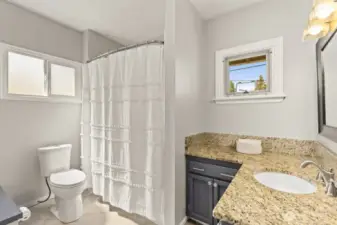 The full bath is set just behind the kitchen—nicely out of the way and perfect for keeping things private.