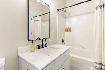 Main-floor bathroom with new counters, sinks, and faucets—one of three updated baths in the home.