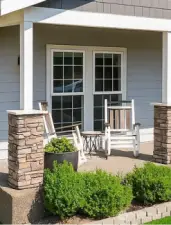 Charming front porch for relaxing and low-maintenance lawn care for easy living.