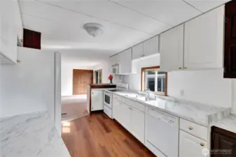 Kitchen features new countertops, new double sink, new luxury vinyl plank flooring, new double pain windows, new light fixture & new dual sinks.