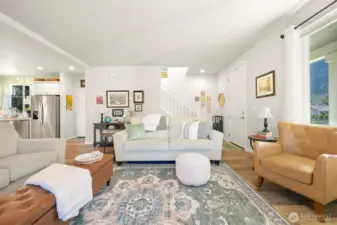 The living room looking back toward the front door and leading upstairs.