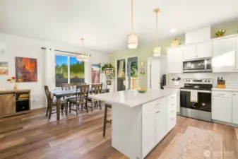 The kitchen and dining room lead out the glass sliding door to the back patio and large backyard.