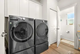 Laundry room with lots of extra storage and the half bath on the main level.