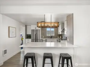 Kitchen with quartz island and bar stool seating