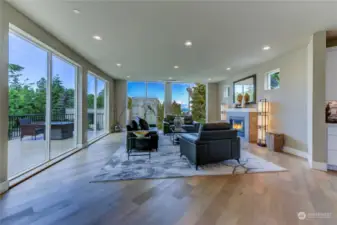 Expansive Living Room with floor to ceiling windows looks West towards the Water.