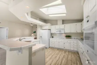 Modern kitchen with white cabinets has an abundance of cabinets.