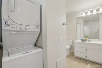 Primary Bathroom with stackable w/d and newer water heater.