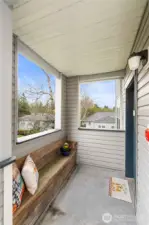 Welcome guests in style with this inviting covered front porch, featuring a custom built-in bench—perfect for enjoying a quiet moment outdoors or setting down groceries with ease. Thoughtfully designed for both comfort and practicality, this space adds personality and function to your private entry. Surrounded by trees and elevated views, it’s the perfect spot to take in the peaceful surroundings before stepping inside.
