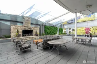 Cozy outdoor terrace featuring comfortable seating and dual gas grills, ideal for entertaining and relaxation.