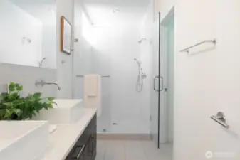 A fresh, spa-like bathroom with dual sinks and a walk-in shower.