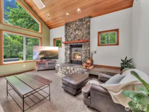 The cozy family room is complete with a full river rock wood burning fireplace. The fireplace will heat up almost the entire home.