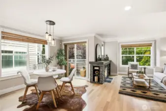 Dining and living flow together naturally, framed by large windows that pull in soft light.
