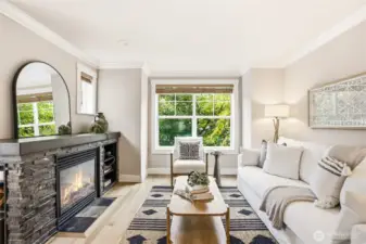 Sleek stacked stone with a dark mantle adds weight and texture, grounding the airy palette.