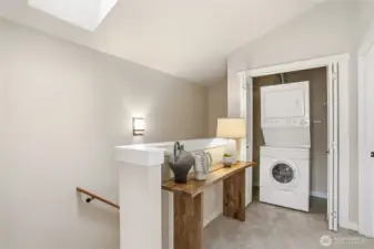 Stacked washer and dryer tucked neatly behind folding doors, right where you need them (adjacent the two upper level en-suites).