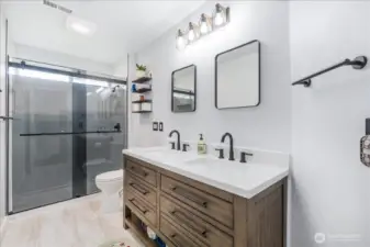 Hall Bath remodeled, luxury vinyl floors, double sink, smoked glass doors