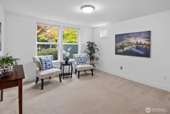 Flexible lower-level room ideal for home office, media room, or guest space with large windows for natural light. It has its own bathroom.