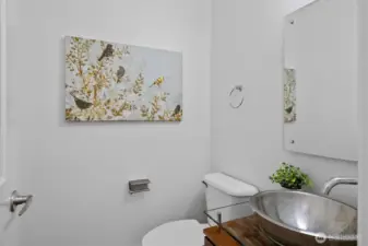 Convenient main-level powder bath with modern vessel sink and sleek fixtures.