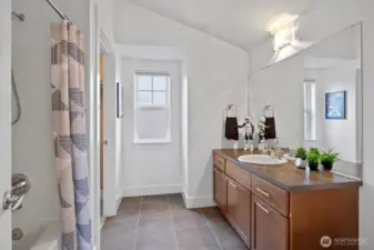 Upper-level Bedroom full bath with contemporary finishes and tile flooring.