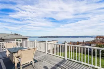 A door leads straight out to this professionally built and fully-enclosed deck with open views of the Salish Sea.