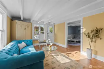 Beamed ceilings extend throughout the main floor with its front sitting rooms. Find a convenient 1/2 bath in the back corner.