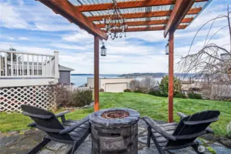 The flagstone patio and fire table covered by a pergola is one more place to relax with a view.