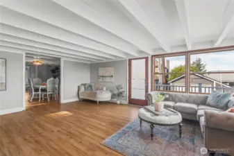 The spacious living room opens into the central dining room.