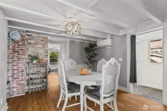 Notice the beamed ceilings, exposed brick, and the opening on the right into a laundry room.