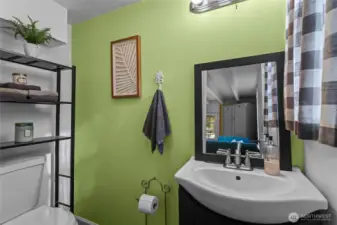 The main floor half bath waits at the back of the front sitting room.