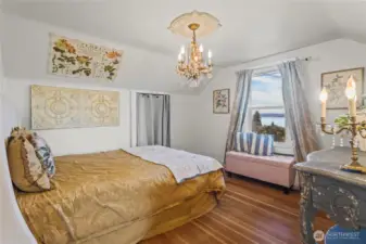A view bedroom stands at the top of the stairs with a north window looking out to the sound. Don't miss the fir floors with all their color and character.