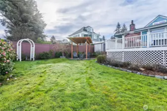 Garden beds border the lawn and deck with plenty of open space for sunshine.