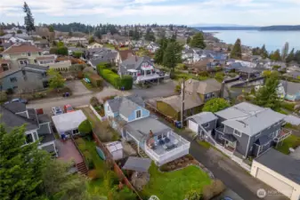 The professionally build retaining wall borders the alley with steps leading up to the lawn. Notice the Olympic Mountains in the distance.