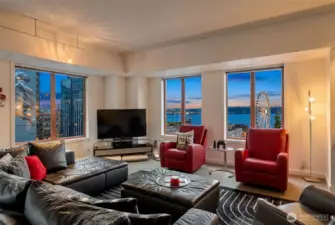 Light-filled corner living room with expansive windows and open entertaining space.