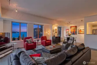 Generous living area with comfortable seating and dramatic sunset views.