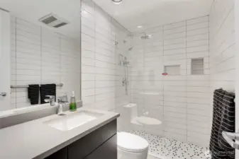 Just off the entrance is this 3/4 bath with walk-in shower. Both bathrooms were updated in 2018 with new cabinets, floors, countertops, full-tiled walls, toilets, faucets, etc.