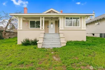 Front of home with steps to the inviting covered porch.