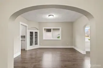 Flexible dining or sitting area off the kitchen with arched entryway.