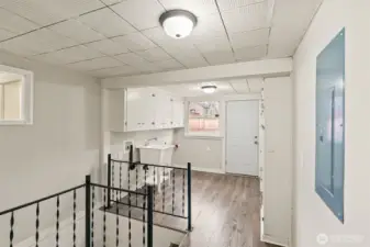 Staircase leading to lower level near mudroom.