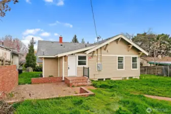 Backyard with brick patio area perfect for entertaining.