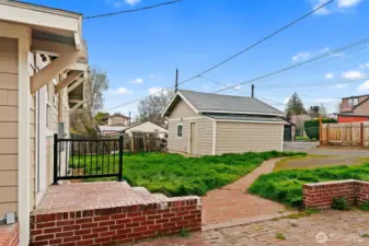 Back entry with brick stair access.