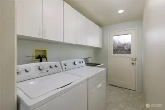 Large laundry/mud-room w/ backyard access & utility sink to help contain messes