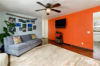 View towards entry & kitchen area off living room. TV stays w/ home