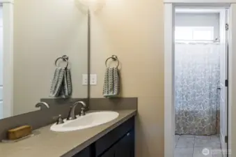 Hall full bath has separate shower/tub and toilet area.