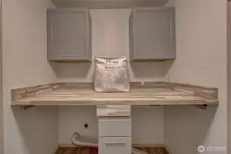 Main level laundry room with beautiful butcher block folding counter.
