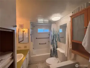 Bathroom with nice size bathtub.