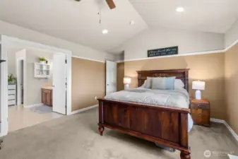 Roomy primary bedroom with pitched ceiling